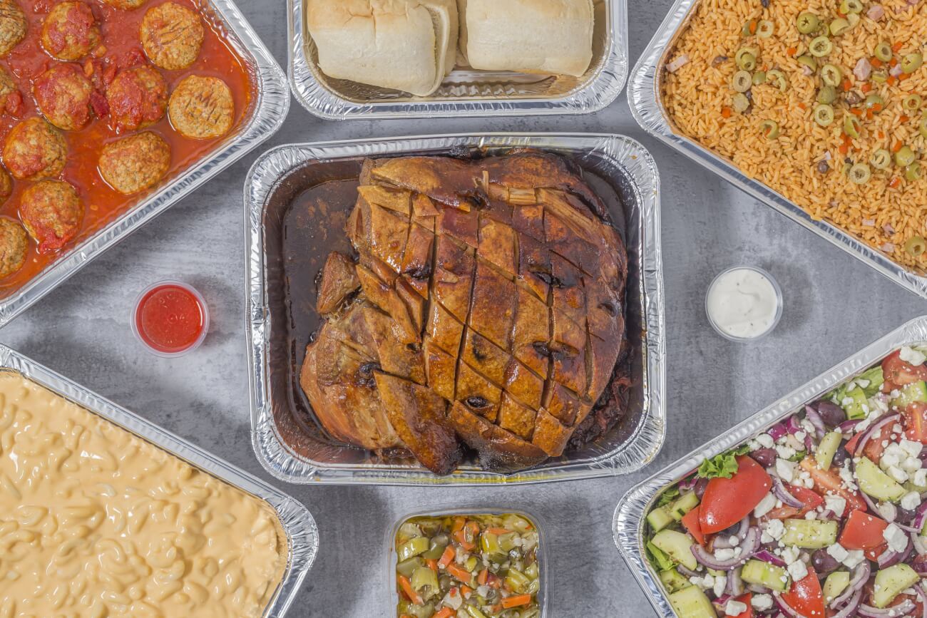 Tony's Fresh Market Catering Glamour Shot of the Pernil, Meatballs, Puerto Rican Rice, Mac & Cheese, and Greek Salad.